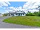 Charming single-story home featuring a covered front entrance, attached carport, and spacious yard with mature trees at 4503 Colony Rd, New Smyrna Beach, FL 32168