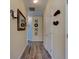 Hallway with wood-look flooring, wall decor and access to rooms at 4503 Colony Rd, New Smyrna Beach, FL 32168
