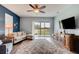Bright living room with a comfortable sectional sofa, large TV, and sliding glass doors to the backyard at 4503 Colony Rd, New Smyrna Beach, FL 32168