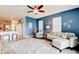 Comfortable living room featuring blue walls, ceiling fan, rug, and contemporary furnishings and decor at 4503 Colony Rd, New Smyrna Beach, FL 32168