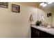 A modern powder room features a granite countertop, decorative mirror, and beach-themed decor at 4503 Colony Rd, New Smyrna Beach, FL 32168