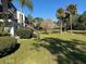A view of community with lawn and palm trees, showcasing the landscape of the condominium at 4555 Tower Pine Rd # Ge, Orlando, FL 32839