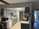 Well-lit kitchen with stainless steel appliances and ample gray cabinets offers a modern cooking space at 4555 Tower Pine Rd # Ge, Orlando, FL 32839