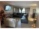 Cozy living room with large sectional sofa, TV, and natural light creates a comfortable atmosphere at 4555 Tower Pine Rd # Ge, Orlando, FL 32839