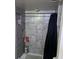 The shower features tiled walls with built-in shelving and a sleek shower curtain at 4555 Tower Pine Rd # Ge, Orlando, FL 32839
