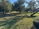 Expansive grassy yard surrounded by mature trees, providing a serene outdoor space at 4555 Tower Pine Rd # Ge, Orlando, FL 32839