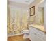 Well-maintained bathroom with a stylish vanity and a shower with a decorative shower curtain at 4670 Links Village Dr # B102, Ponce Inlet, FL 32127