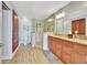 Well-lit bathroom showcasing a granite counter top, a glass enclosed shower, and wooden cabinets at 4670 Links Village Dr # B102, Ponce Inlet, FL 32127