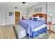 Bright and airy bedroom features a large bed, ensuite bath, and stylish decor at 4670 Links Village Dr # B102, Ponce Inlet, FL 32127