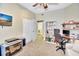 Cozy room with a ceiling fan, closet, open doorway and a desk area with a bookcase at 4670 Links Village Dr # B102, Ponce Inlet, FL 32127