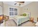 Serene bedroom with large windows, a comfortable bed, and relaxing decor at 4670 Links Village Dr # B102, Ponce Inlet, FL 32127