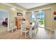 Cozy dining room featuring a classic wooden table and chairs, with sliding glass doors to a patio at 4670 Links Village Dr # B102, Ponce Inlet, FL 32127