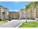 Large condo complex with covered parking, tropical landscaping, and well maintained grounds at 4670 Links Village Dr # B102, Ponce Inlet, FL 32127