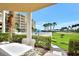 Relaxing views of the golf course and palm trees from the patio area of the condo at 4670 Links Village Dr # B102, Ponce Inlet, FL 32127