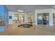 A soothing hot tub with a muraled wall and views to the community gym and outside at 4670 Links Village Dr # B102, Ponce Inlet, FL 32127