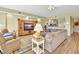 Spacious living room with wood floors, a ceiling fan, and an entertainment center at 4670 Links Village Dr # B102, Ponce Inlet, FL 32127