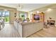 Bright and airy living room with a large sectional couch and sliding glass doors showcasing an outdoor view at 4670 Links Village Dr # B102, Ponce Inlet, FL 32127