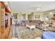 Open-concept living room featuring a large sectional sofa, wood floors, and seamless access to the kitchen at 4670 Links Village Dr # B102, Ponce Inlet, FL 32127