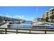 A wide marina view featuring rows of boats docked along the waterway, with condo buildings and a blue sky overhead at 4670 Links Village Dr # B102, Ponce Inlet, FL 32127