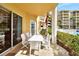 Relaxing patio area with view of pool and landscaping, perfect for outdoor dining and relaxation at 4670 Links Village Dr # B102, Ponce Inlet, FL 32127