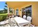 Inviting covered patio with outdoor dining set, perfect for enjoying the pleasant views at 4670 Links Village Dr # B102, Ponce Inlet, FL 32127