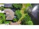 Aerial view of a beautiful home with mature trees and a lake in the back at 508 Quail Lake Dr, Debary, FL 32713