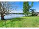 Expansive backyard with lush green grass and peaceful lake views, perfect for outdoor enjoyment at 508 Quail Lake Dr, Debary, FL 32713
