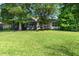 Backyard features a covered patio and views of the lush landscaping at 508 Quail Lake Dr, Debary, FL 32713