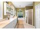 Elegant bathroom showcasing double vanity, soaking tub, and glass-enclosed shower with natural light from the window at 508 Quail Lake Dr, Debary, FL 32713