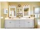 Well-lit bathroom with double sinks, framed mirrors, storage cabinets, and elegant fixtures at 508 Quail Lake Dr, Debary, FL 32713