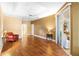 Bright bedroom featuring hardwood floors, neutral walls, and a sliding glass door to a private balcony at 508 Quail Lake Dr, Debary, FL 32713