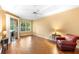 This primary bedroom features hardwood floors, a ceiling fan, and a screened-in porch at 508 Quail Lake Dr, Debary, FL 32713
