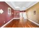 Cozy bedroom featuring hardwood floors, tray ceiling and ample natural light at 508 Quail Lake Dr, Debary, FL 32713