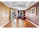 Comfortable bedroom with hardwood flooring, tray ceiling, and a sitting area at 508 Quail Lake Dr, Debary, FL 32713