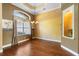 Elegant dining room with hardwood floors, decorative window, and custom lighting at 508 Quail Lake Dr, Debary, FL 32713