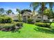 Attractive single-story home with a lush green lawn, beautiful landscaping, and a serene setting at 508 Quail Lake Dr, Debary, FL 32713