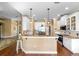 Open kitchen with white cabinets, granite countertops and stainless steel appliances at 508 Quail Lake Dr, Debary, FL 32713
