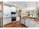 Well-lit kitchen features white cabinetry, granite countertops, and stainless steel appliances at 508 Quail Lake Dr, Debary, FL 32713