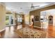 Open-concept living room featuring hardwood floors, crown molding, and access to the backyard at 508 Quail Lake Dr, Debary, FL 32713