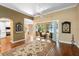 Bright living room with hardwood floors and sliding glass doors to a sunroom overlooking the water at 508 Quail Lake Dr, Debary, FL 32713