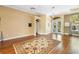 Inviting living room with hardwood floors, decorative rug, and French doors at 508 Quail Lake Dr, Debary, FL 32713