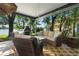 Covered patio features cozy seating, a lake view, and a stylish outdoor rug at 508 Quail Lake Dr, Debary, FL 32713