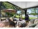 Relax on the screened patio with comfortable seating and a charming fireplace, overlooking the tranquil lake at 508 Quail Lake Dr, Debary, FL 32713