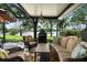 Relax on the screened patio, with comfortable seating, outdoor fireplace, overlooking the tranquil lake at 508 Quail Lake Dr, Debary, FL 32713