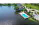Aerial view of the community waterfront pool area with lounge chairs and cabana at 508 Quail Lake Dr, Debary, FL 32713