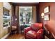 Relaxing sitting area with a comfortable chair, mirror, and window views at 508 Quail Lake Dr, Debary, FL 32713