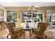 Cozy sunroom with wicker furniture, large windows offering lake views, and a ceiling fan at 508 Quail Lake Dr, Debary, FL 32713