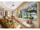 Bright sunroom with tile floors, comfortable seating, and views of the lake at 508 Quail Lake Dr, Debary, FL 32713