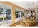 Bright sunroom with tile floors, plenty of windows with outdoor views, and comfortable seating at 508 Quail Lake Dr, Debary, FL 32713
