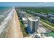 Wide aerial view of condo community with a view of the beach at 5207 S Atlantic Ave # 723, New Smyrna Beach, FL 32169